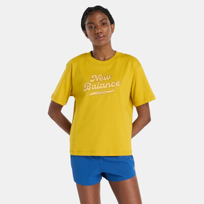 نيو بالانس تيشيرت آثليتكس ليجاسي جرافيك للنساء برتقالي